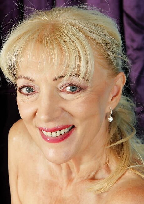 Very attractive blonde granny Janet Lesley in lingerie exhibits her butt and spreads her legs 